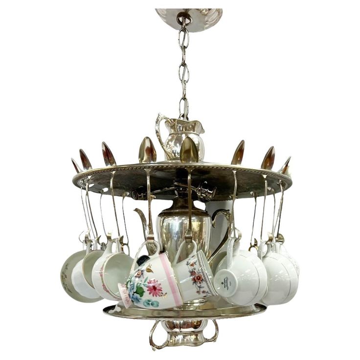 a chandelier with cups and saucers hanging from it