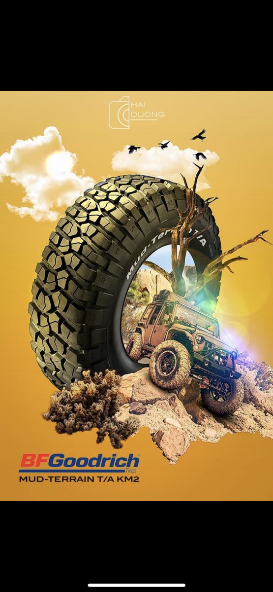 an advertisement for a mud terrain vehicle with birds flying over the tire and tree branches