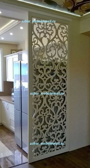 the interior of a kitchen with white cabinets and an intricate design on the door frame