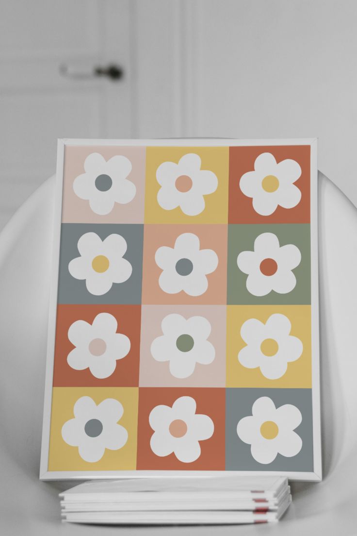 a white chair sitting next to a stack of books