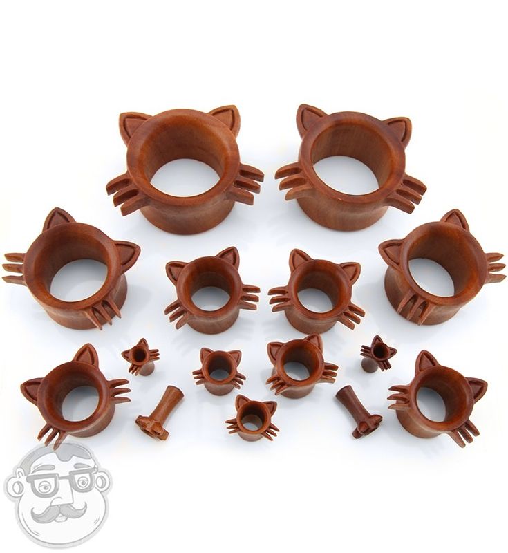 a bunch of wooden cat shaped objects on a white surface