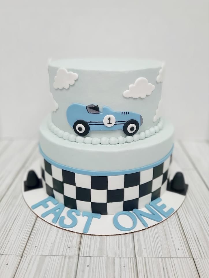 a birthday cake with a racing car on the front and checkerboard design on the back