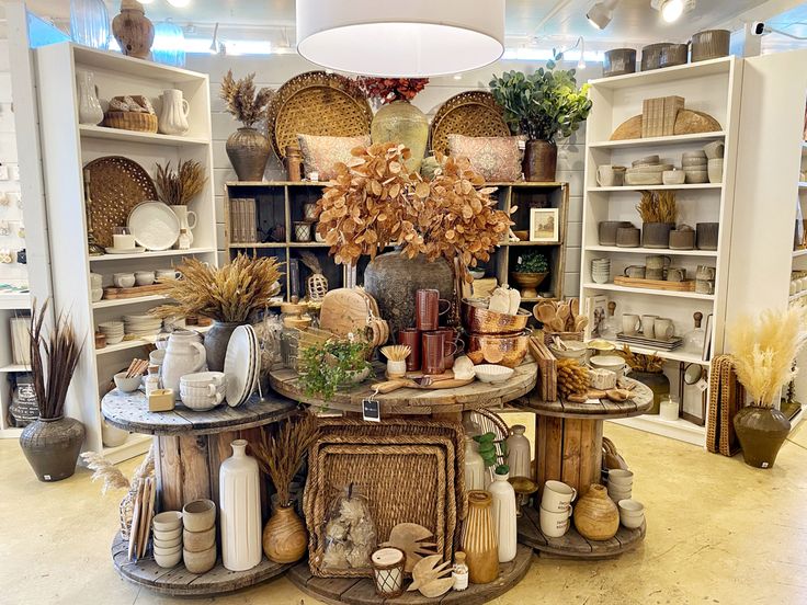 a room filled with lots of different types of vases and other items on display