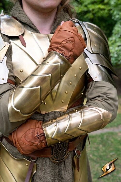 a man dressed as a knight with his arms crossed