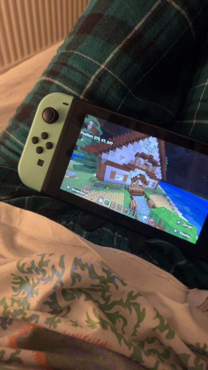 a nintendo wii game controller sitting on top of a bed