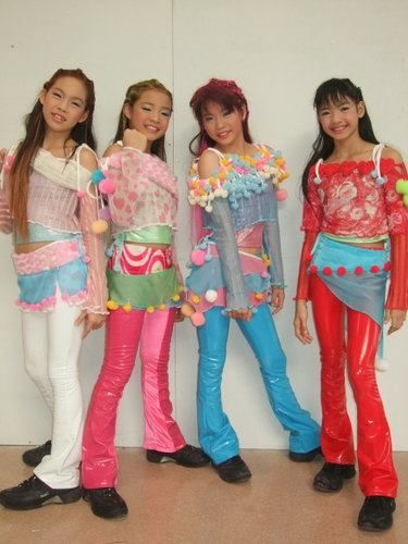 three girls in colorful outfits standing next to each other