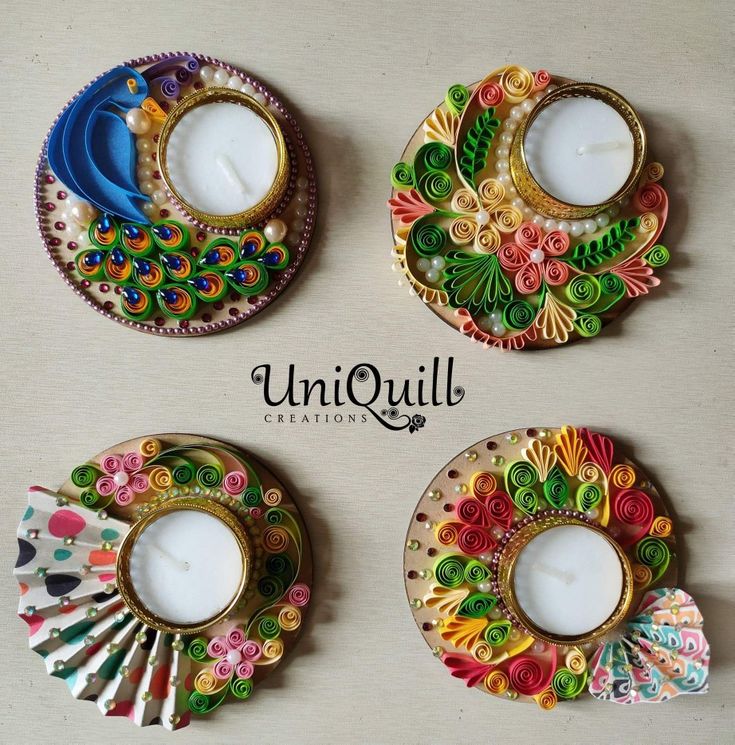 four colorful candles are sitting on a table with the words uni quill written below them