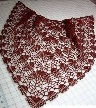 a red crocheted doily on top of a table