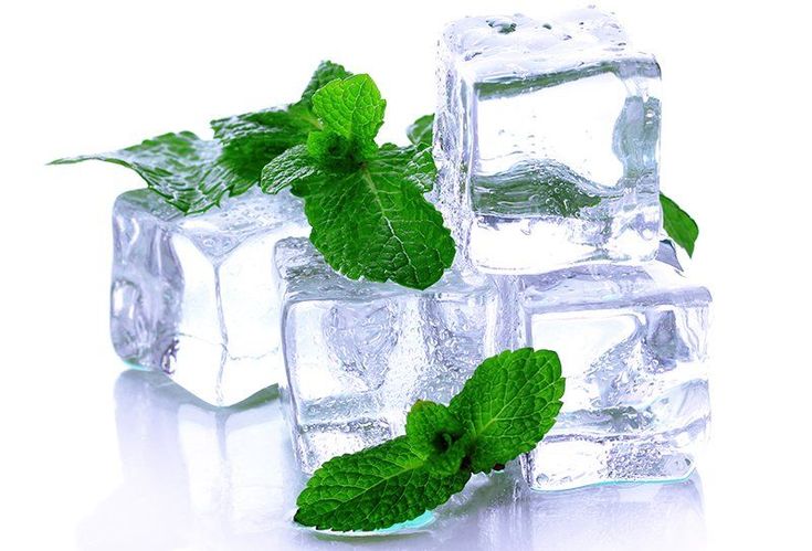 three ice cubes with mint leaves on top