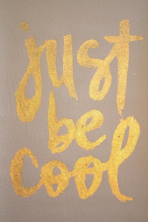 the words just be cool written in yellow ink on a brown background with gold paint