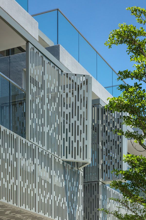 the building is made up of many different shapes and sizes, including vertical lines on the facade