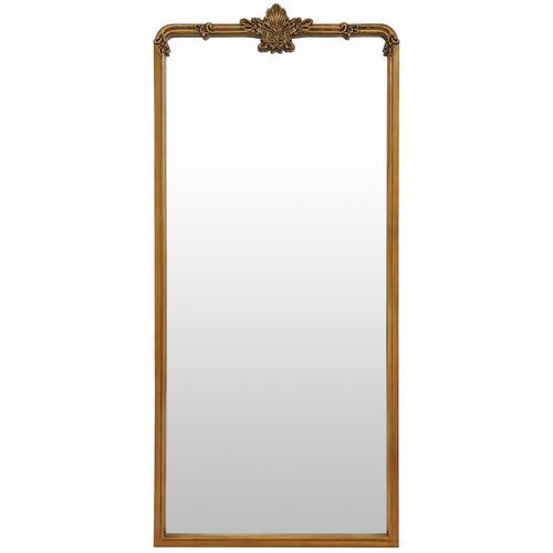 a mirror that is sitting on top of a table with a wooden frame and gold trimming