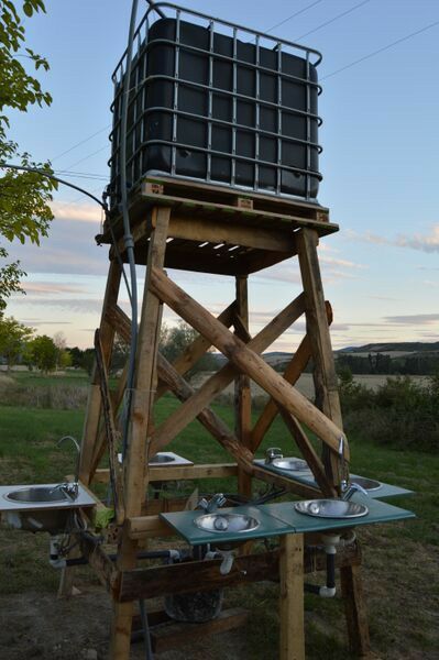 a wooden tower with metal pans on it