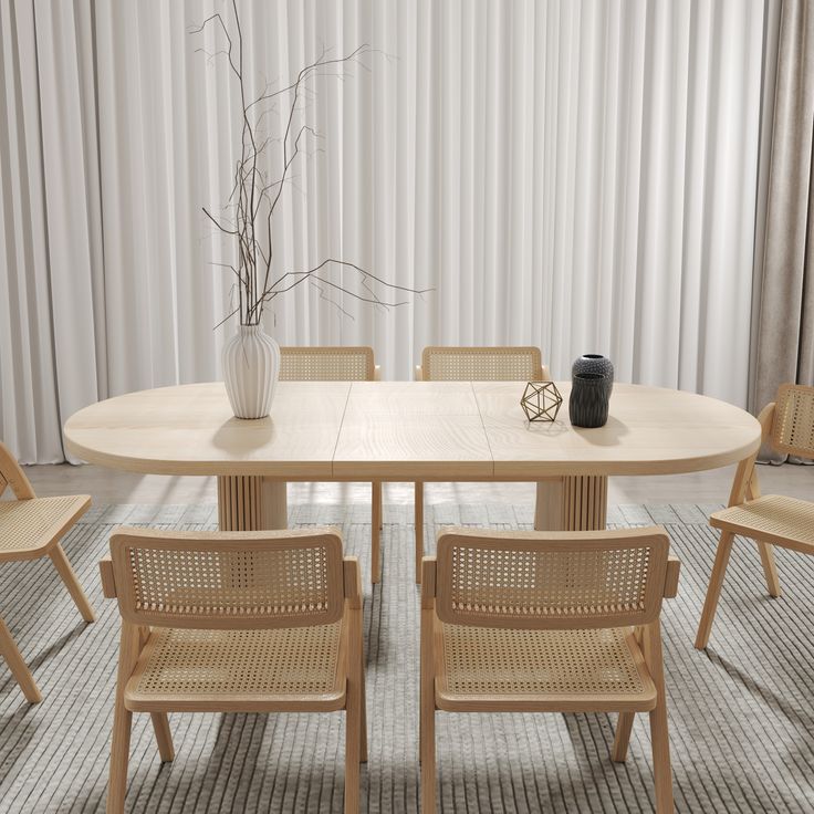 a dining table with four chairs and a vase on the top, in front of a curtained wall