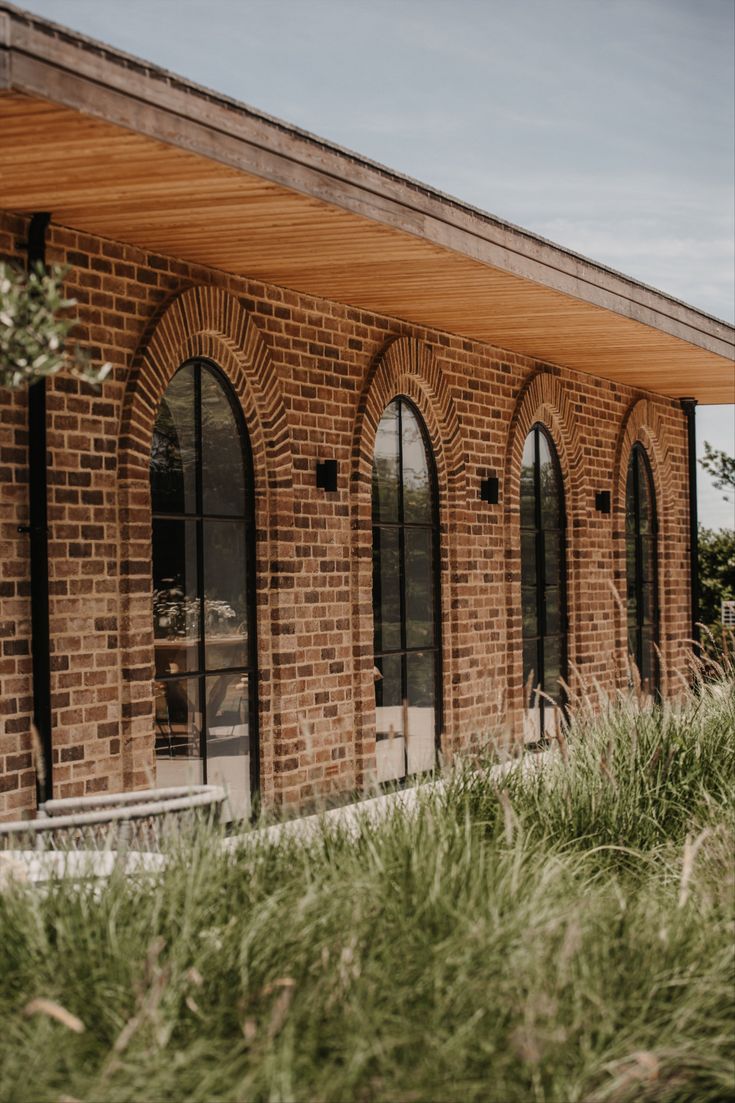 an old brick building with arched glass windows