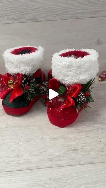 two red and white baby shoes with christmas decorations on them