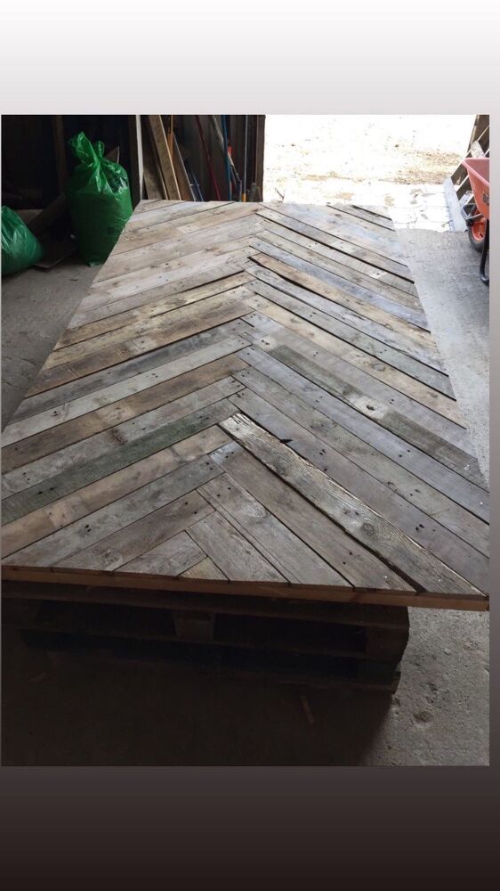 a table made out of wooden planks in a garage