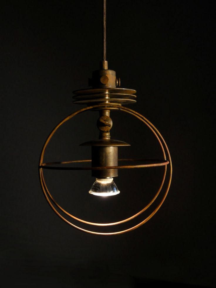 a light fixture hanging from a ceiling in the dark