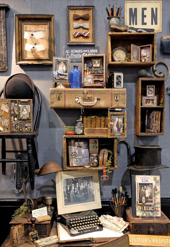 an old fashioned typewriter sitting on top of a desk next to other antique items