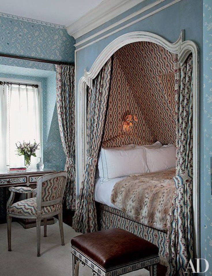 a bedroom with blue walls and white furniture