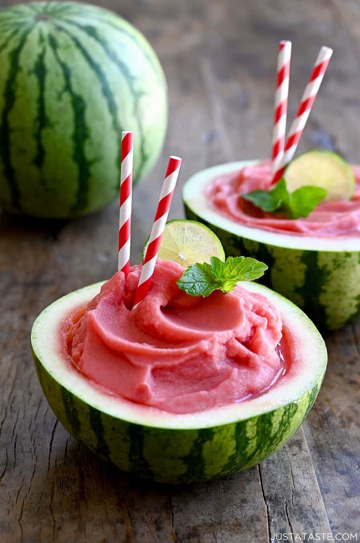 two watermelon cups filled with ice cream and garnished with mint