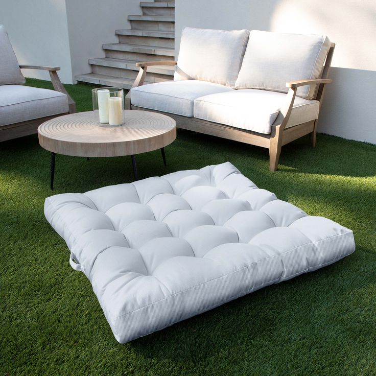 a living room filled with furniture on top of green grass