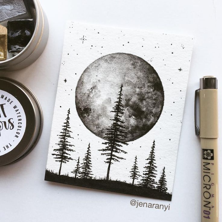 a card with the moon and trees on it, next to some inking supplies