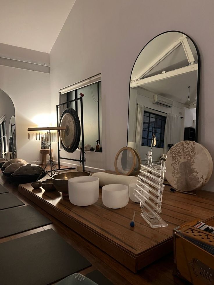 a living room filled with lots of furniture and mirrors on top of a wooden table