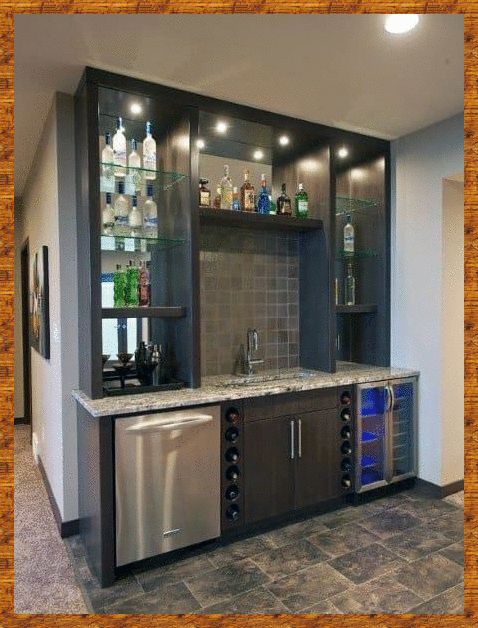 a home bar with built in wine racks and liquor bottles on the shelves, along with stainless steel appliances