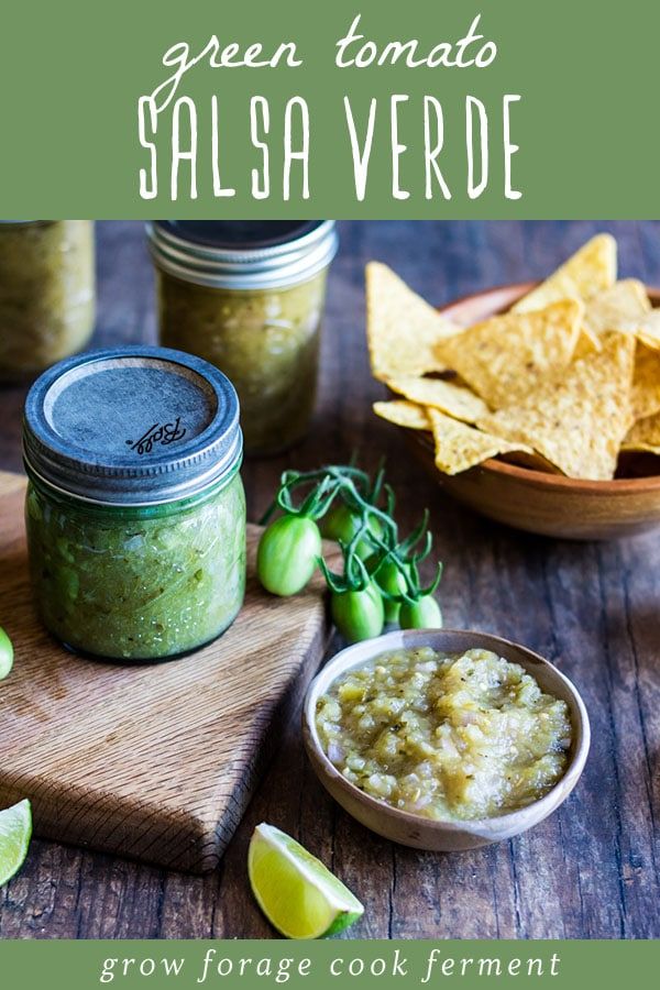 green tomato salsa with tortilla chips and guacamole in the background