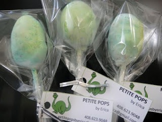 some lollipops are wrapped in plastic and have green frosting on them