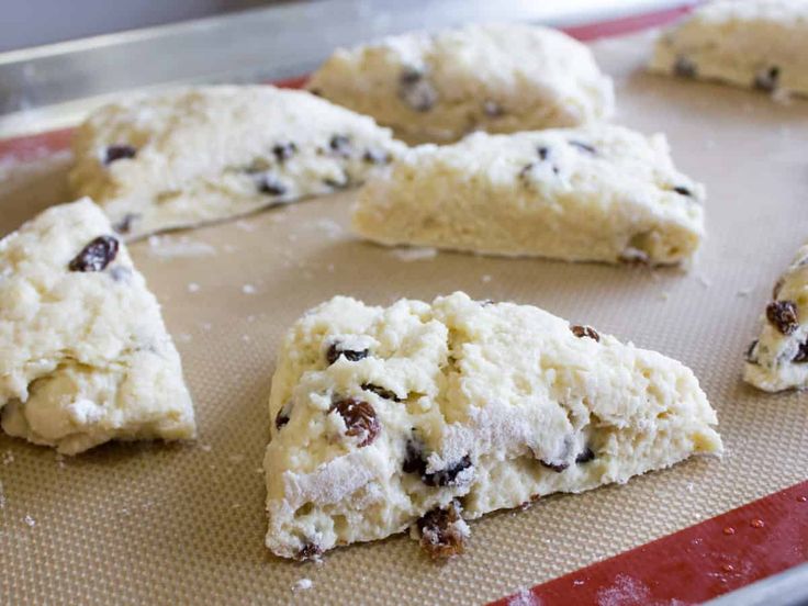 some cookies are on a baking sheet and ready to be baked in the oven or used as an appetizer