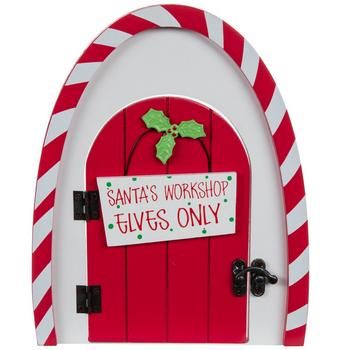 a red and white door with a sign that says santa's workshop gives only