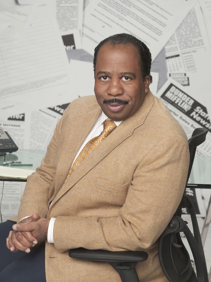 a man sitting in a chair with his arms crossed