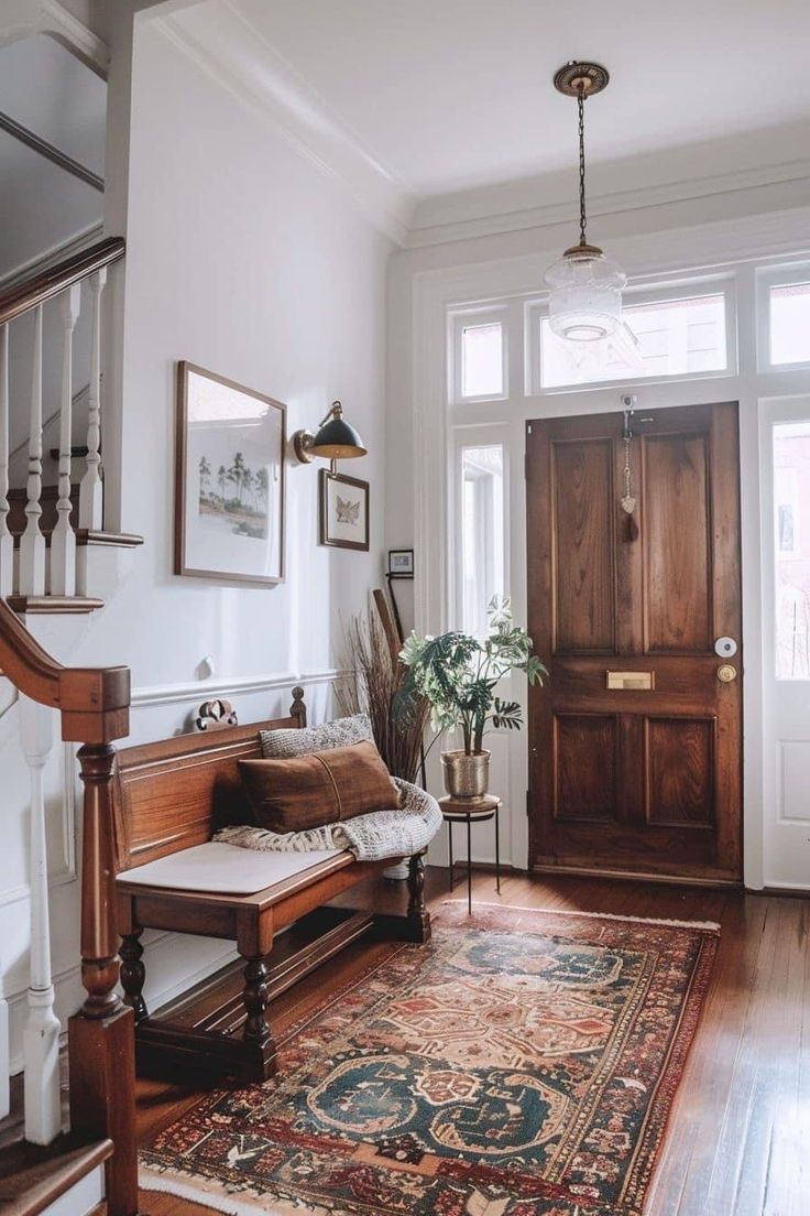 a wooden bench sitting on top of a hard wood floor next to a stair case