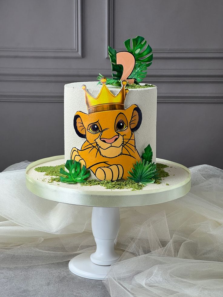 a cake with a lion design on it sitting on top of a white tablecloth