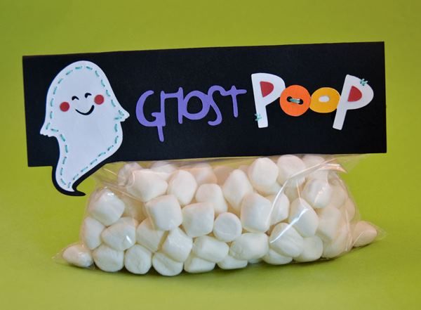 a bag filled with marshmallows next to a sign that says ghost pop