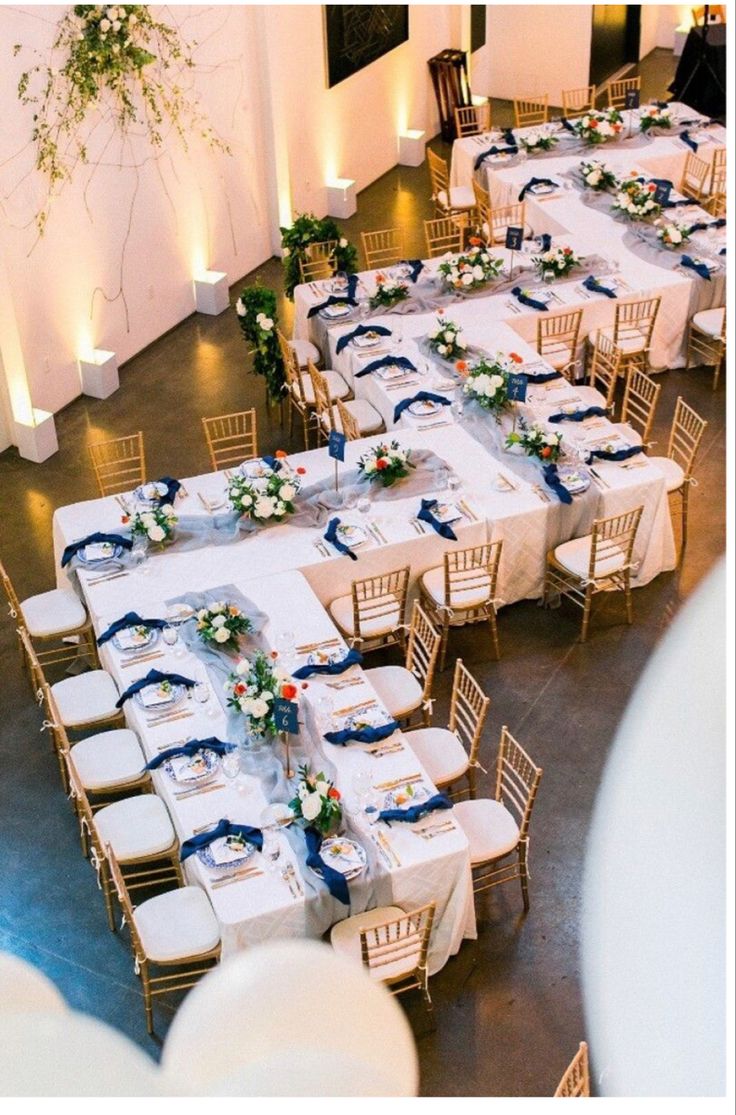 the tables are set up with white and blue linens