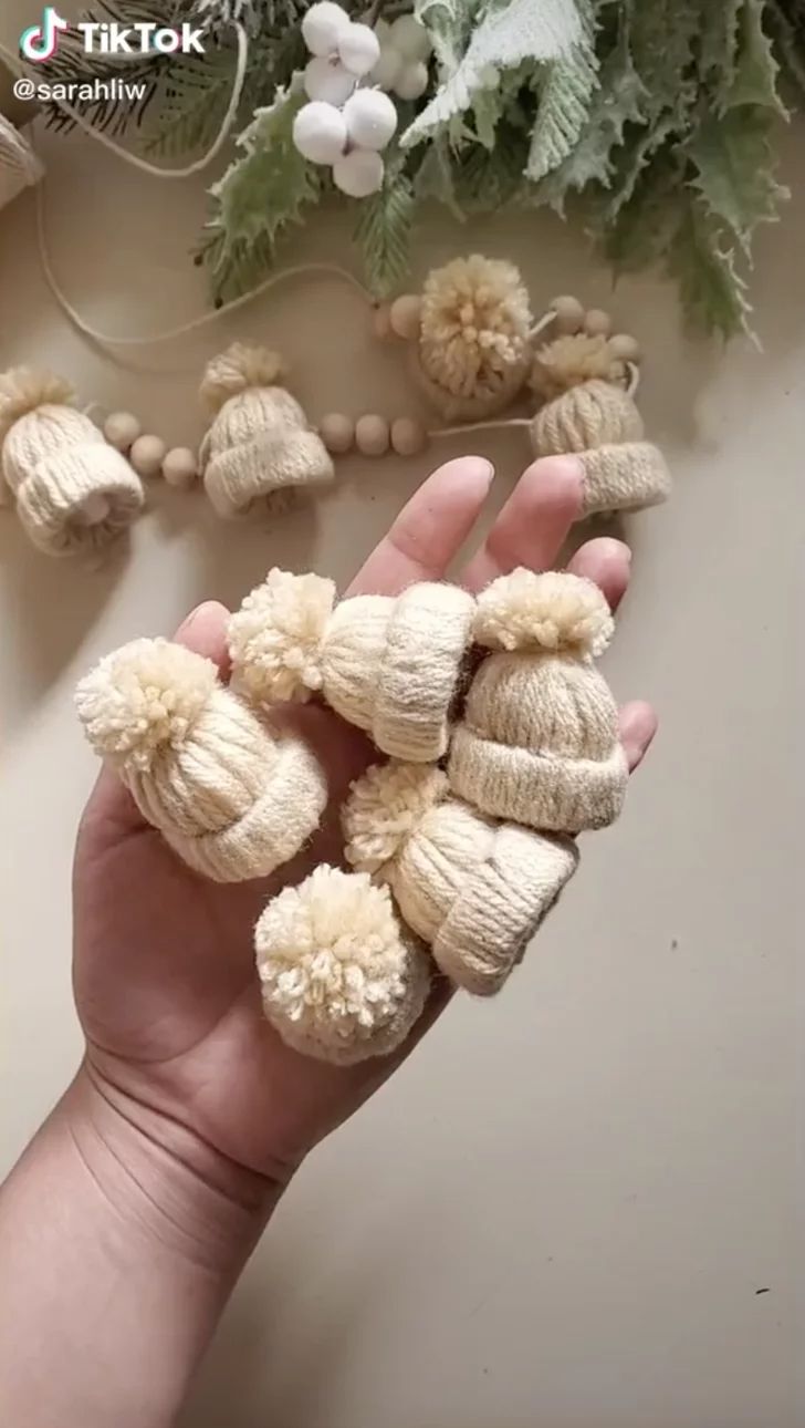 a hand is holding some small white flowers