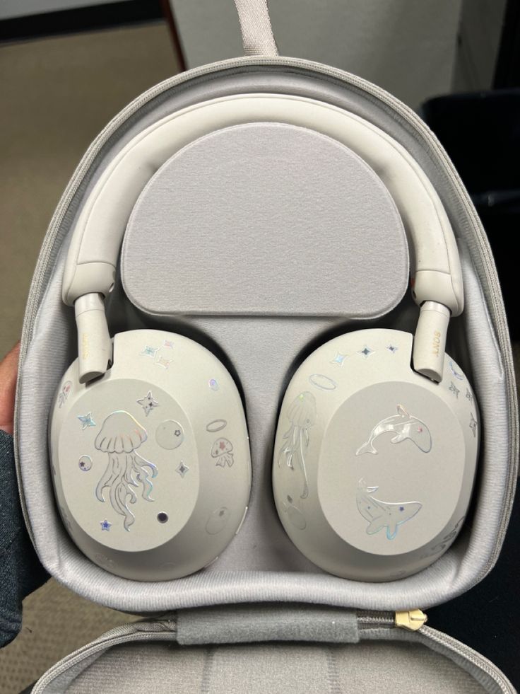 silver sony wh-1000xm5 headphones with rainbow holographic jellyfish, dolphin, and whale stickers Headphone Decoration, Cute Headphones, Sony Headphones, White Headphones, Noise Cancelling Headphones, Birthday Wishlist, الرسومات اللطيفة, Noise Cancelling, Cool Gadgets