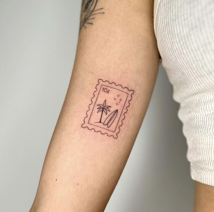 a woman's arm with a stamp on it and a palm tree in the middle