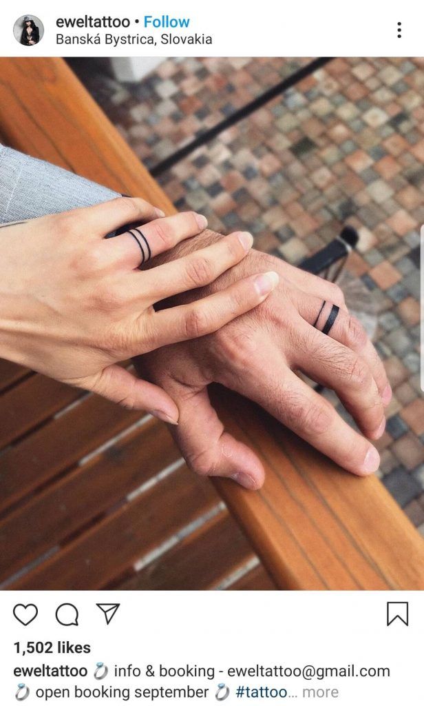 two people holding hands on top of each other with their wedding rings in front of them