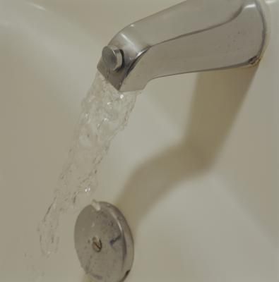 a faucet that is running water from it's spout in a sink