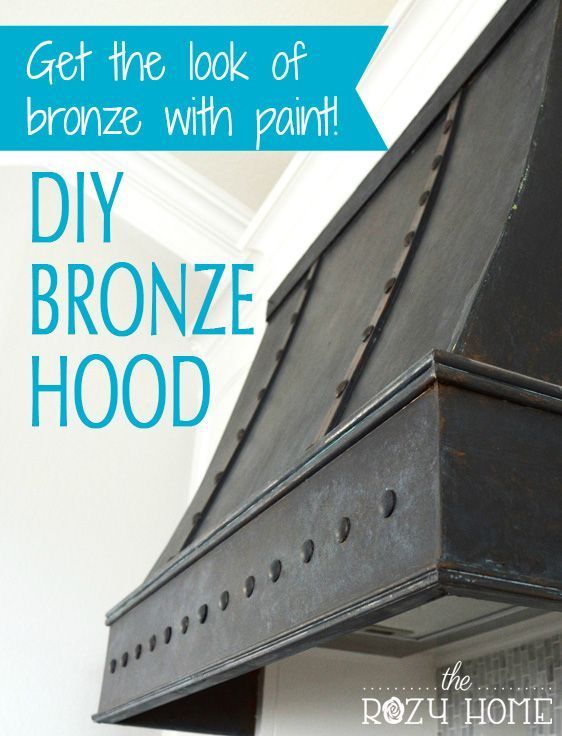 the diy bronze hood has been painted black and is next to a white wall