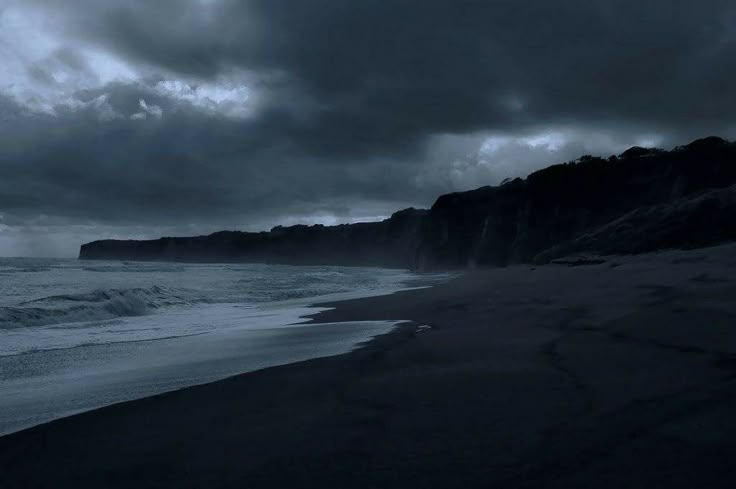 the beach is dark and stormy at night