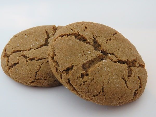 two brown cookies sitting next to each other