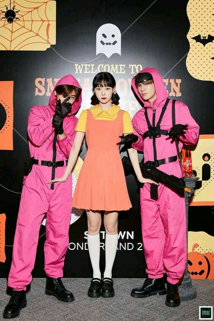 three people in pink costumes standing next to each other and posing for the camera with their hands on their hipss