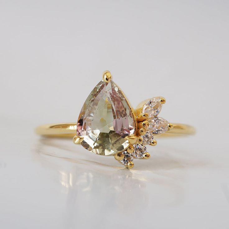 This one of a kind watermelon tourmaline ring with its soft pink and green hue colors will capture your heart. Surrounded with your choice of natural diamonds or CZ. Handcrafted in 14K solid gold. Only one available. 14k solid gold Natural watermelon tourmaline. 8*6mm pear Natural diamonds or CZ 1.25mm ring band ** This item is specially made for you. Please allow 1-2 week lead time. Shipping:Domestic: Free standard shipping within the U.S.International: Free standard shipping for orders over $2 Watermelon Tourmaline Engagement Ring, Watermelon Tourmaline Ring, Tourmaline Engagement Ring, Fall Rings, Yellow Engagement Rings, Tourmaline Jewelry, Tourmaline Ring, Watermelon Tourmaline, Ring Band