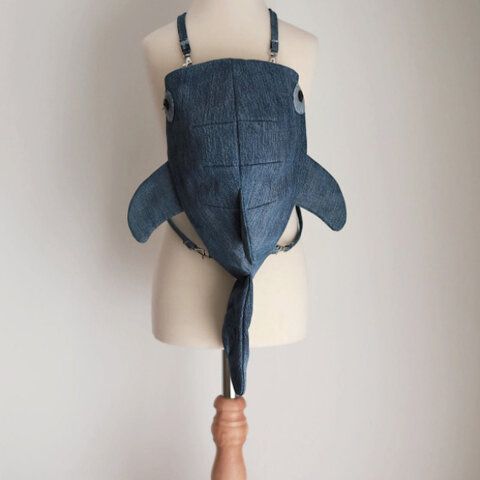 a mannequin head with a blue denim shark mask on it's face