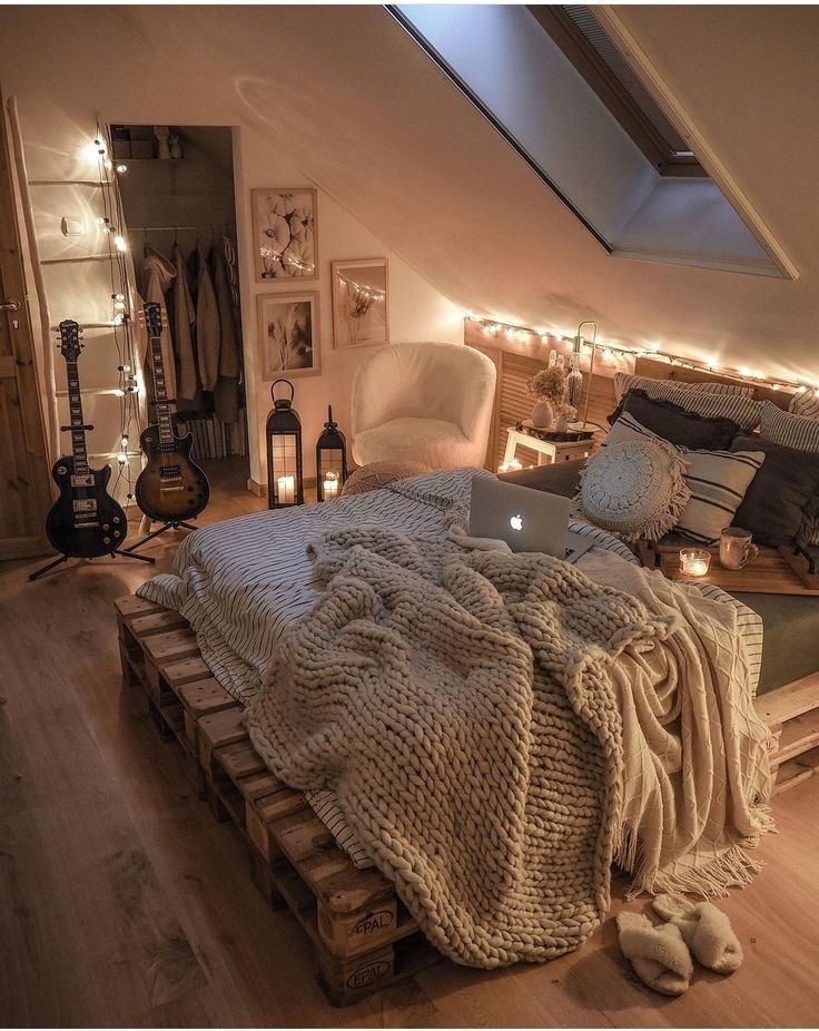 a bedroom with a bed made out of wooden pallets and lights on the wall